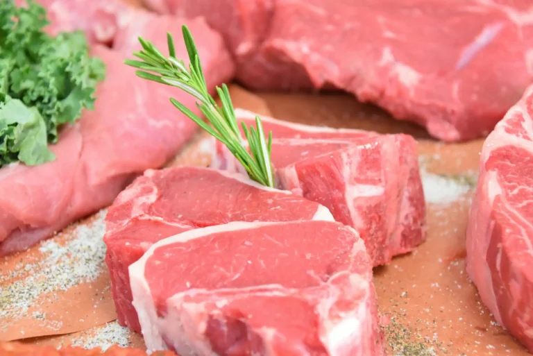 Pork meat. Fresh pork steaks on cutting board with ingredients for cooking.
